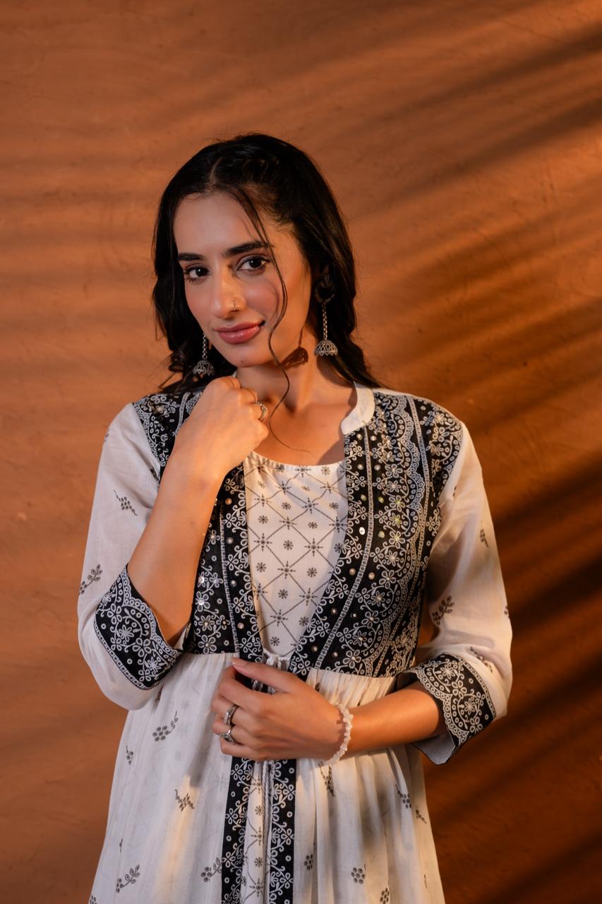 Close-up of black block print jacket overlay with mirror work accents and geometric yoke panel on white cotton Anarkali dress - Jagranee