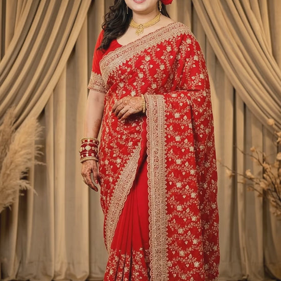 Front view of red georgette saree with gold floral zardozi jaal and scalloped zari border, studio backdrop - Jagranee