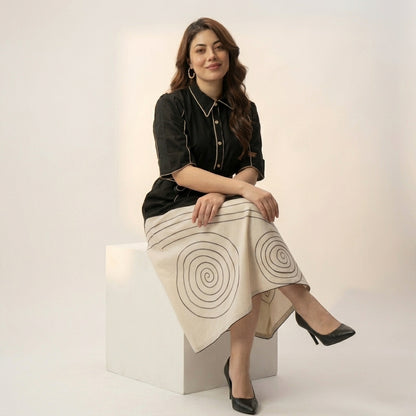 Black Ivory Spiral Cotton Blend Midi Dress — Elegant Sitting 
Pose Showing Full Colour Block Skirt — Jagranee Jaipur