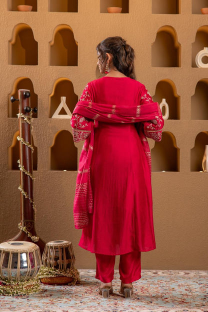 Back view of rani pink Viscose Silk kurta set showing gold embroidered sleeves and zari dupatta drape - Jagranee
