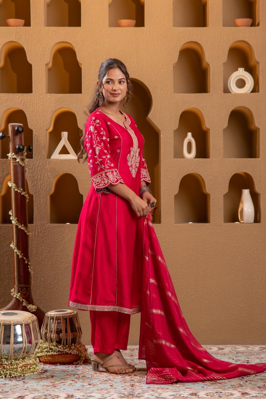 Side profile of rani pink Viscose Silk kurta set showing embroidered sleeves and gold zari dupatta drape - Jagranee