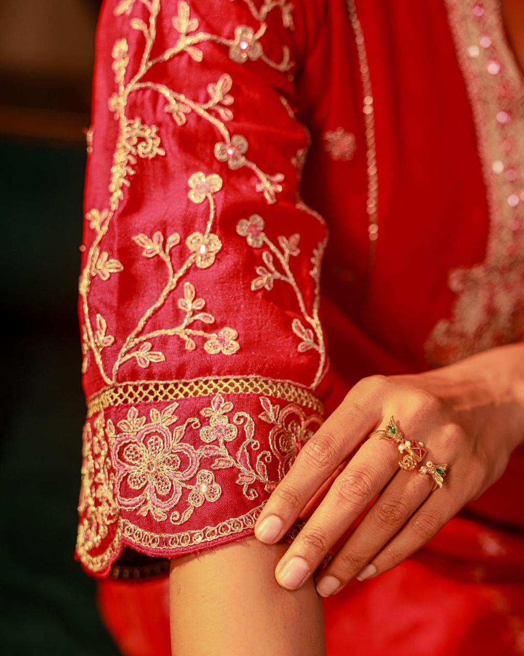 Close-up detail of gold floral vine embroidery and scalloped cuff with jali lattice work on rani pink Viscose Silk sleeve - Jagranee