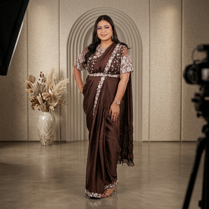 Front view of dark brown satin silk saree with sequin embroidered border and sheer net blouse with all-over floral embroidery - Jagranee