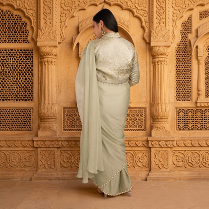 Back detail of gold zari brocade jacket blouse with full sleeves and high collar over sage green saree - Jagranee