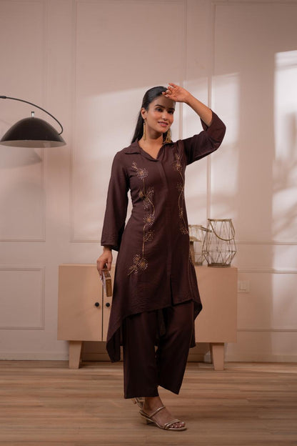 Lifestyle pose in dark brown sequin embroidered high-low kurta set with balloon sleeves and palazzo pants - Jagranee
