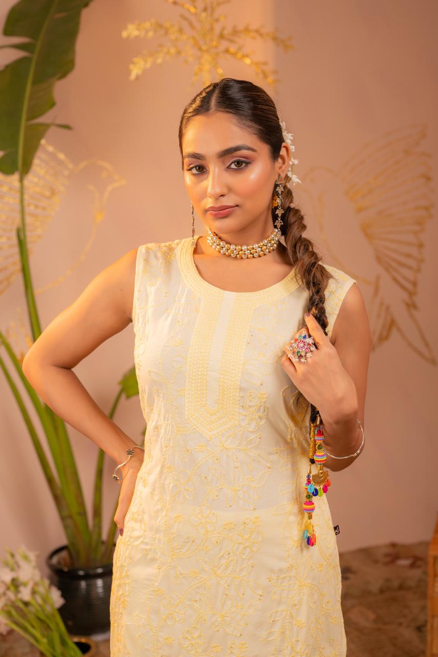 Close-up portrait showing chikankari embroidery detail on lemon yellow kurta with pearl choker - Jagranee