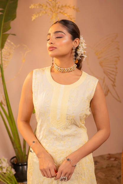 Close-up of round neckline and chikankari yoke embroidery on lemon yellow pure cotton kurta with flowers in hair - Jagranee