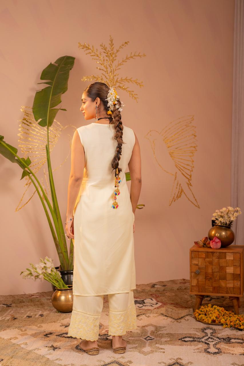 Back view of lemon yellow chikankari sleeveless kurta set showing clean back and embroidered pants hem - Jagranee