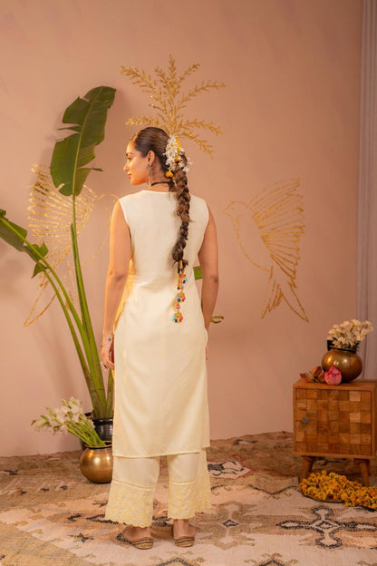 Back view of lemon yellow chikankari sleeveless kurta set showing clean back and embroidered pants hem - Jagranee