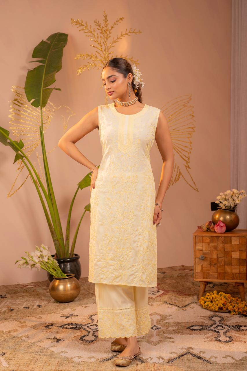 Full body lifestyle pose in lemon yellow chikankari embroidered pure cotton sleeveless kurta set - Jagranee