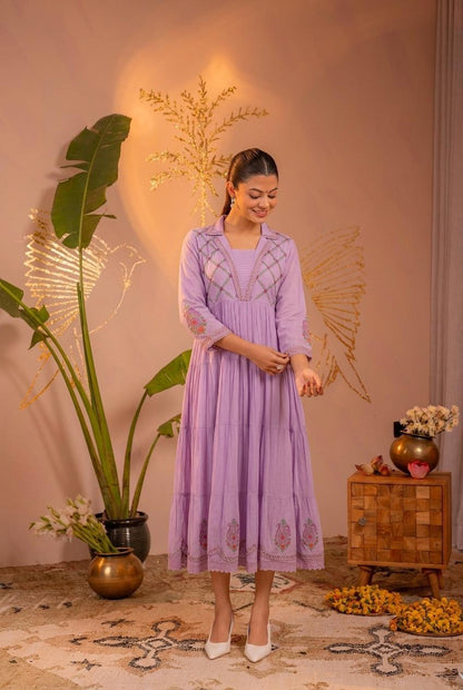 Front view of lavender embroidered tiered midi dress with collar neck and paisley motifs on lower tier - Jagranee