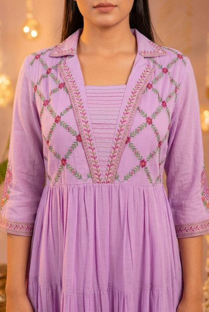 Close-up of diamond lattice embroidery with pink rosettes and green leaf trails on lavender cotton dress bodice - Jagranee