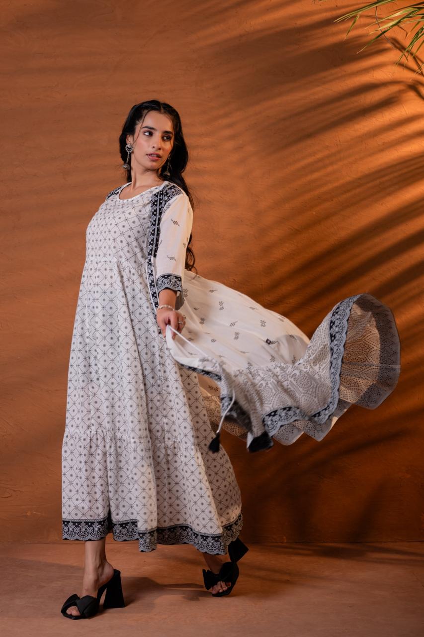 Side view of black and white block print tiered Anarkali dress showing mandala print lower tier and scalloped hem in motion - Jagranee