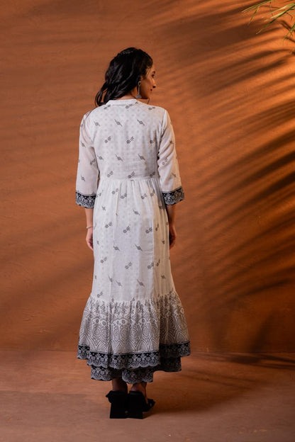 Back view of black and white block print cotton Anarkali dress showing buti print body and mandala tiered hem - Jagranee